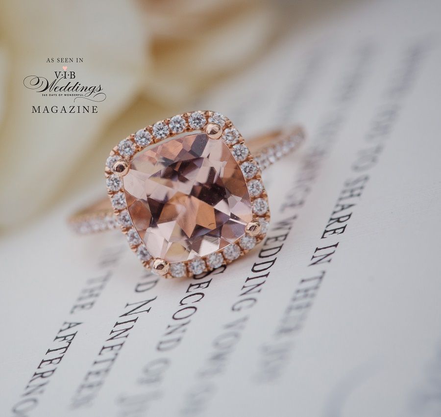 A wedding ring is sitting on top of a wedding invitation.