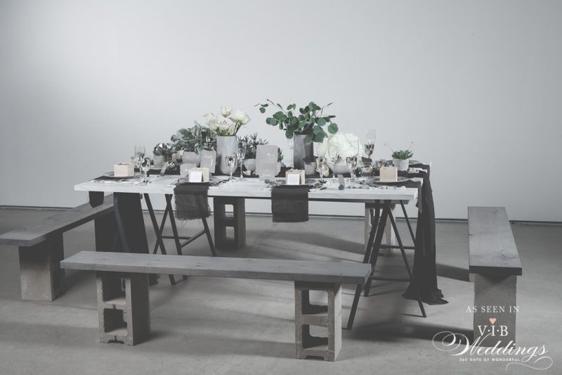 A black and white photo of a table set for a wedding reception.