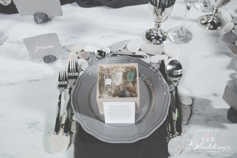 A place setting with a plate , silverware , and a card on it.