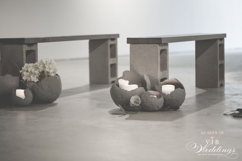 A black and white photo of a couple of benches made out of concrete blocks.