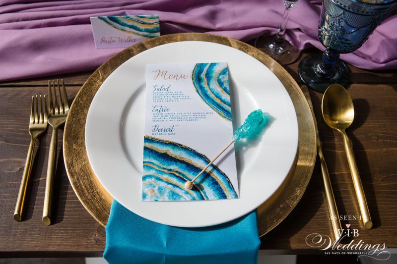 A white plate with a menu on it is on a wooden table.