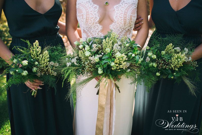 A bride and her bridesmaids are holding bouquets of green flowers.