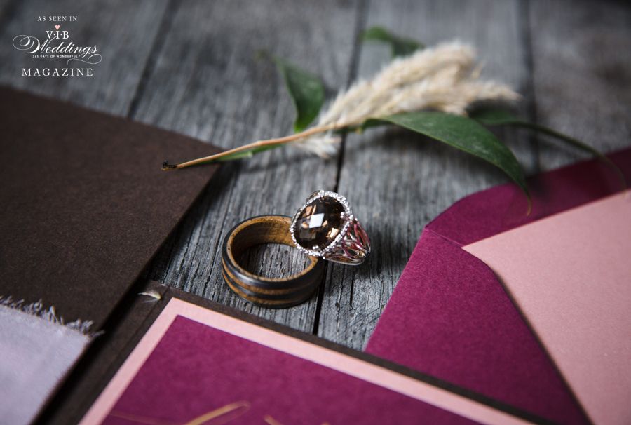 A couple of wedding rings sitting on top of a purple envelope.