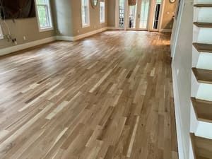 Empty living room with light wood floors and built-in shelves