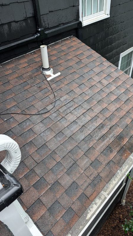 A close up of a gutter on the side of a roof.