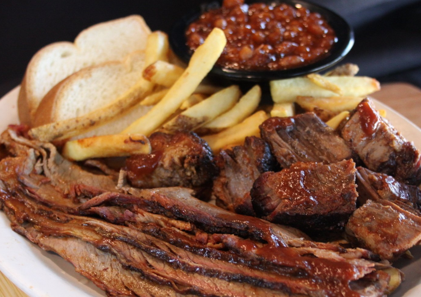 Grilled meat , french fries and baked beans Smokehouse bbq restaurant kansas city