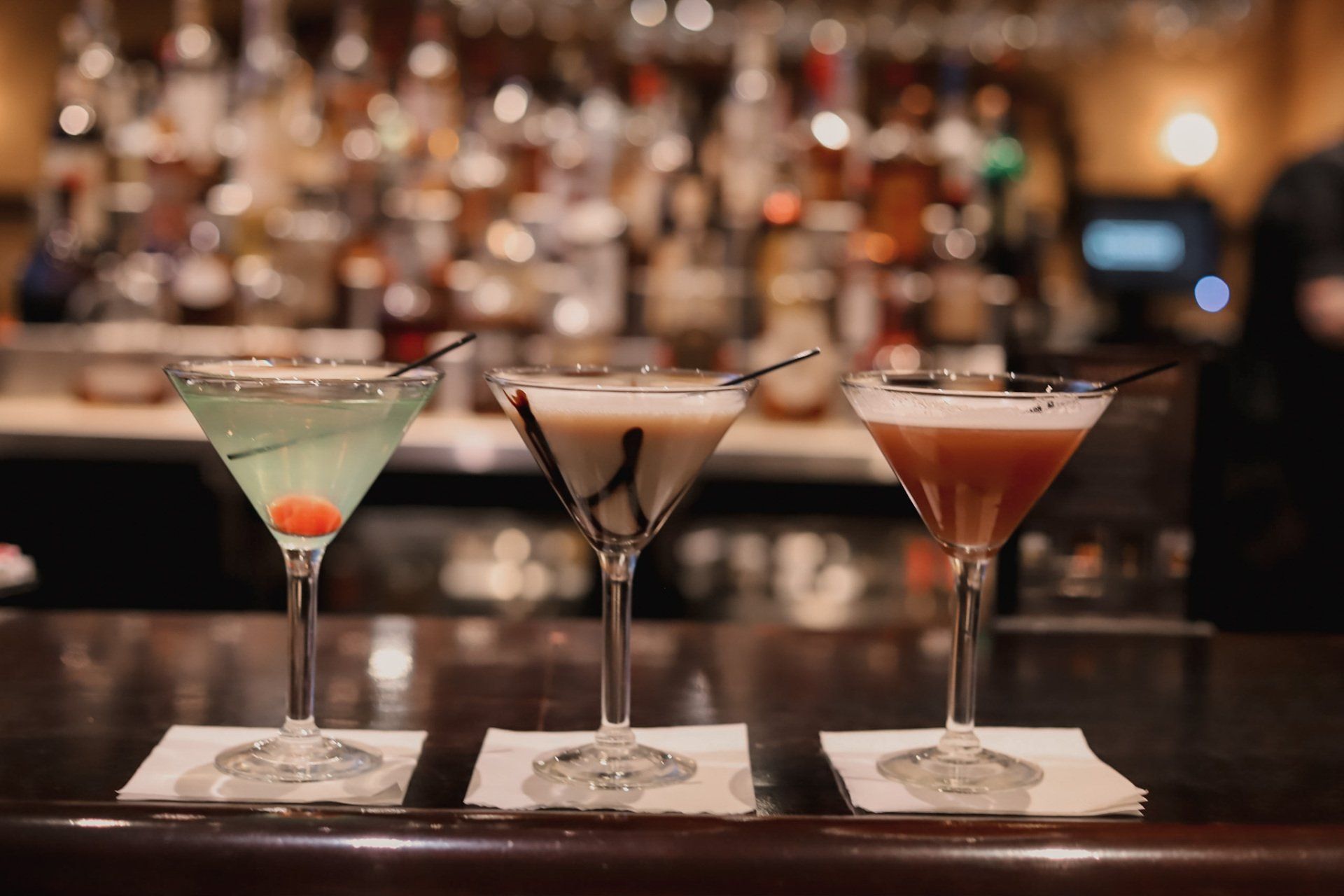 Three cocktail glasses arranged together, ready to serve drinks