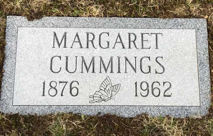 Gravestone for Margaret Cummings, 1876–1962, with a carved butterfly.