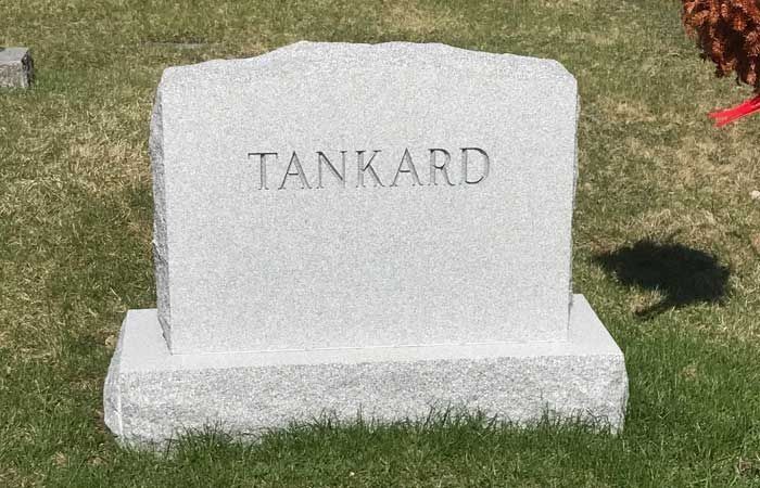 Gray gravestone engraved “TANKARD” on a grassy lawn