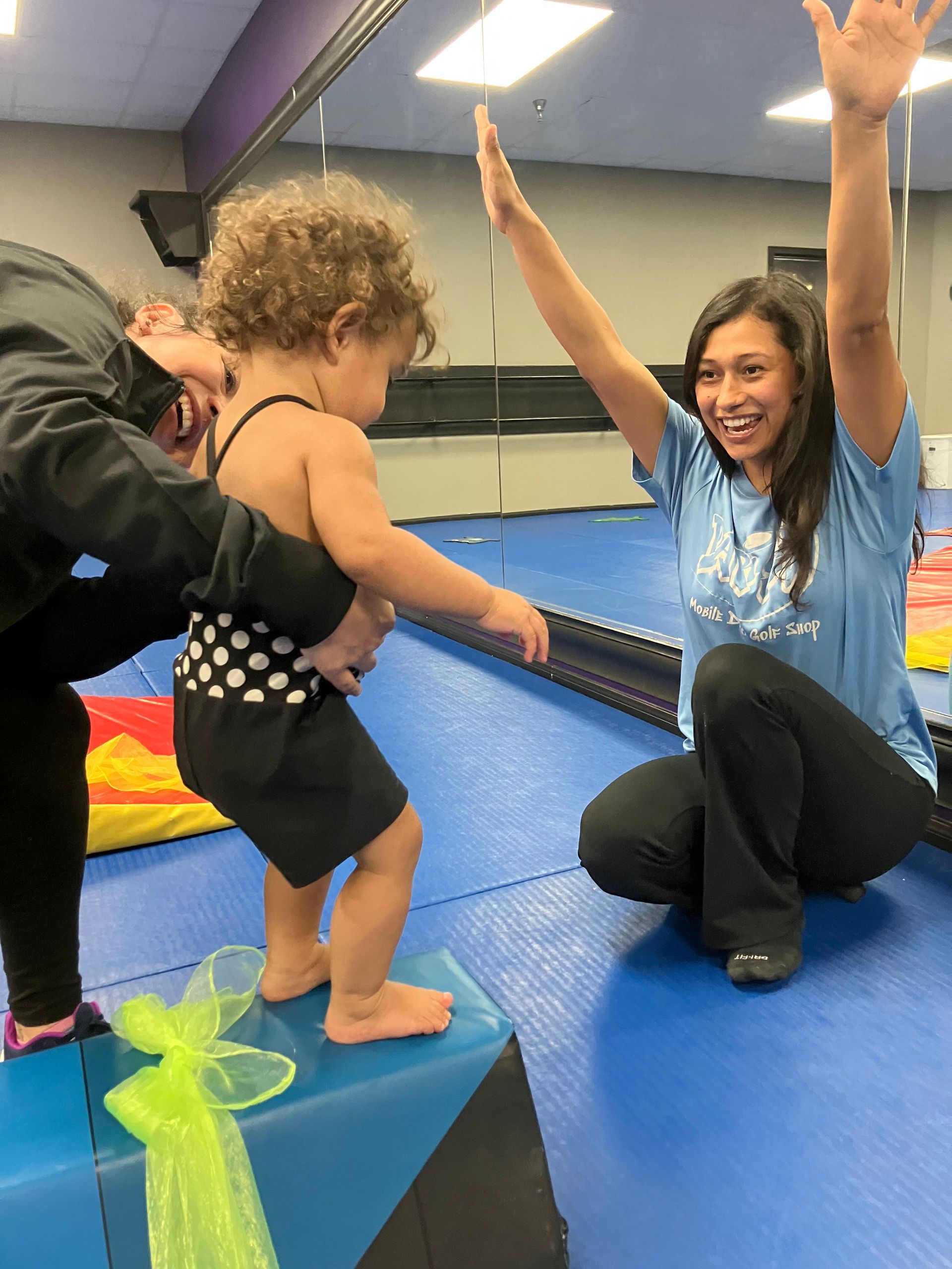 Parent and toddler participating in a Parent & Me gymnastics class