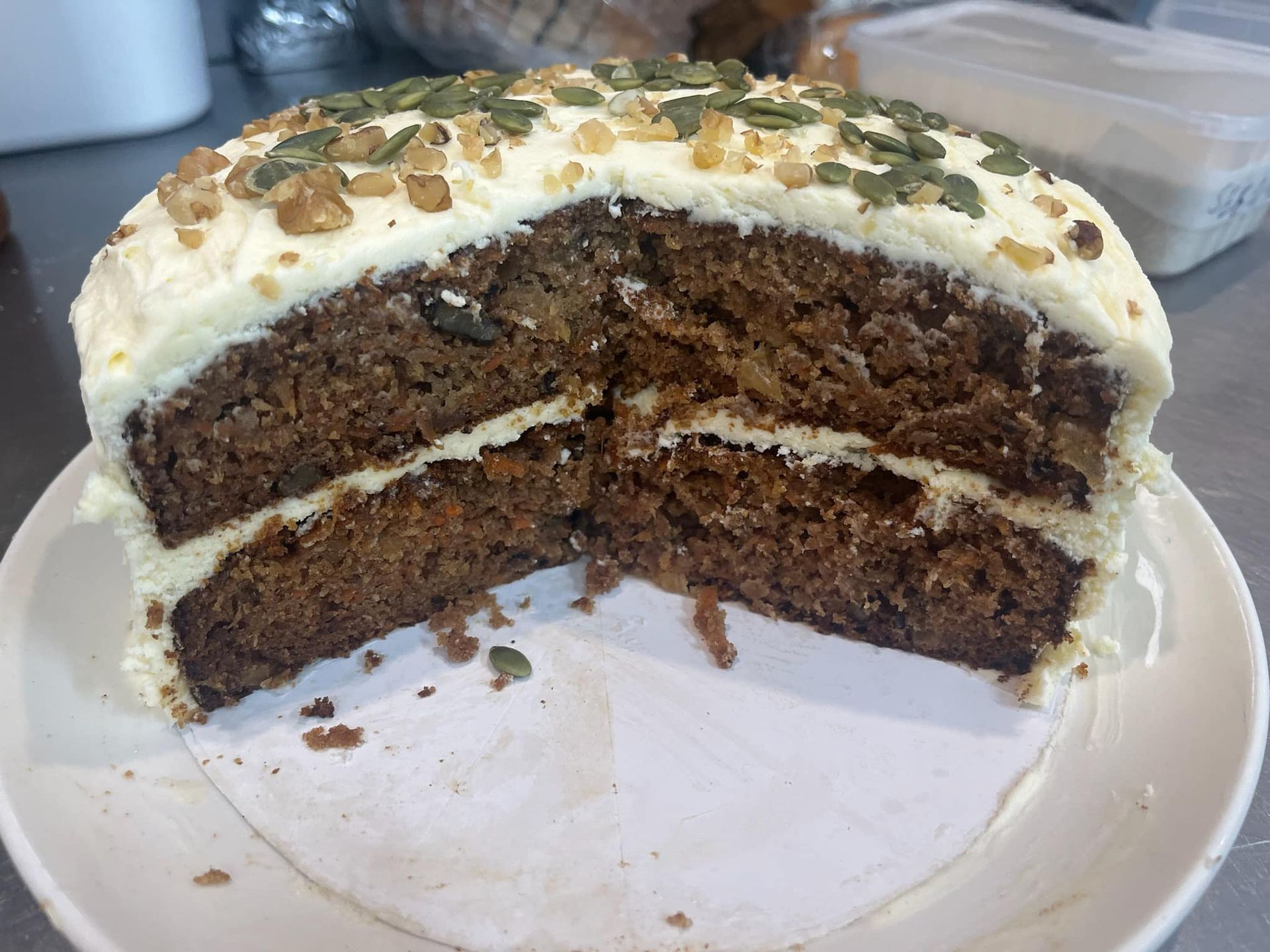 Carrot Cake Topped With Nuts and Seeds, Served on a White Plate — 321 Cafe Learmonth In Learmonth, VIC