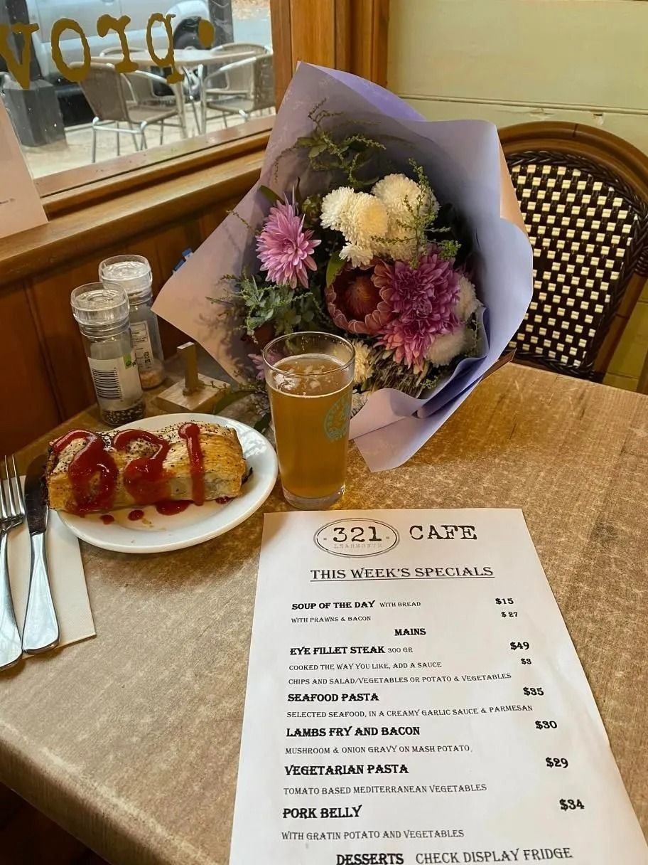 Table Setting With Flowers, Food, Beer, and Menu Inside a Cafe — 321 Cafe Learmonth In Learmonth, VIC