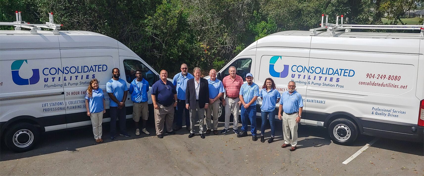 Two Company Vans & A Group Of Employees