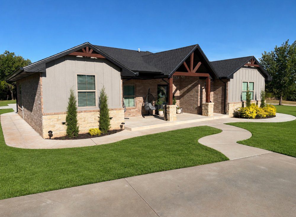 Single-story modern house with stone accents, front porch, and a curved walkway with green lawn