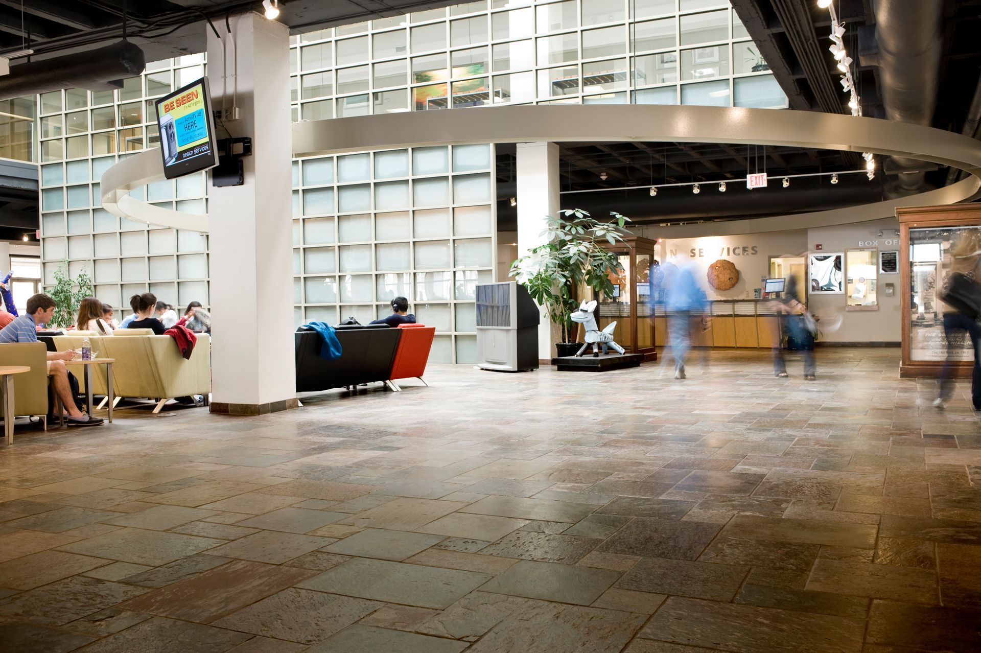 A blurred image of a lobby with people walking around