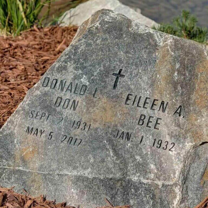 Engraved boulder memorial with companion names