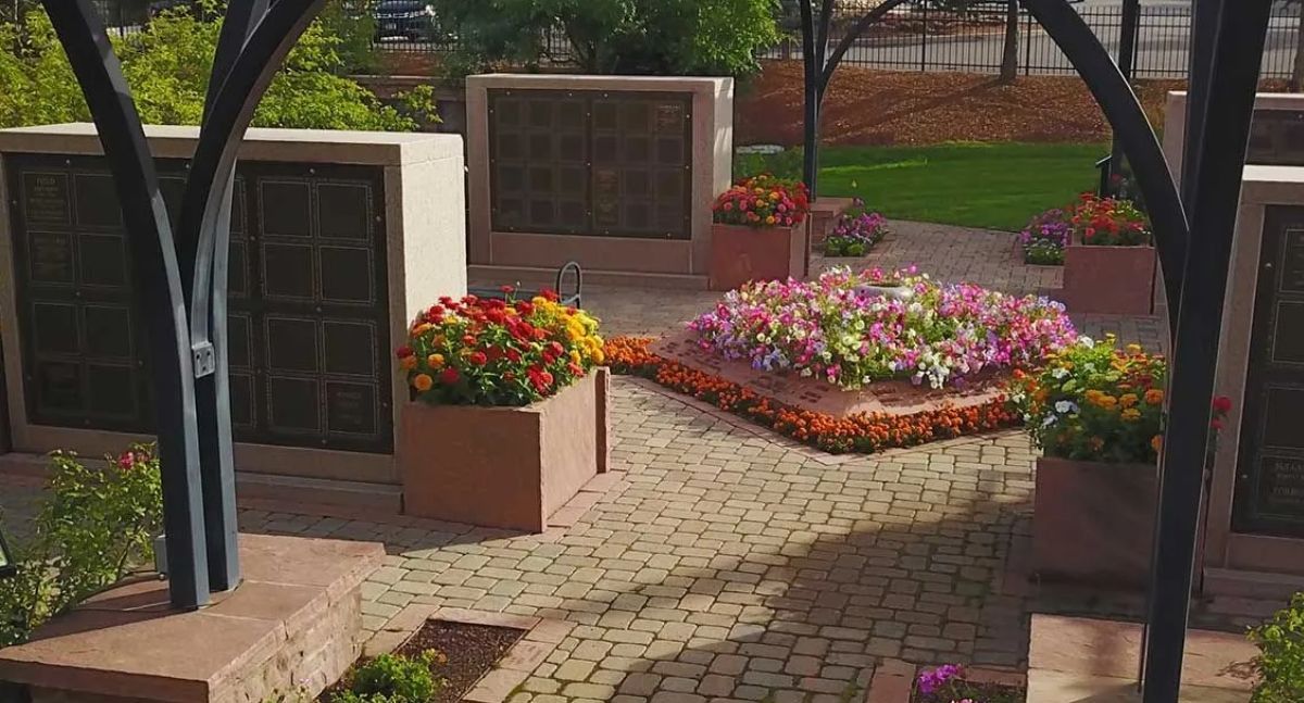 Columbarium niches with flowers on paver path
