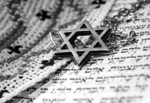 Star of David resting on Hebrew scripture, representing Jewish funeral services and respectful religious and cultural memorial traditions.