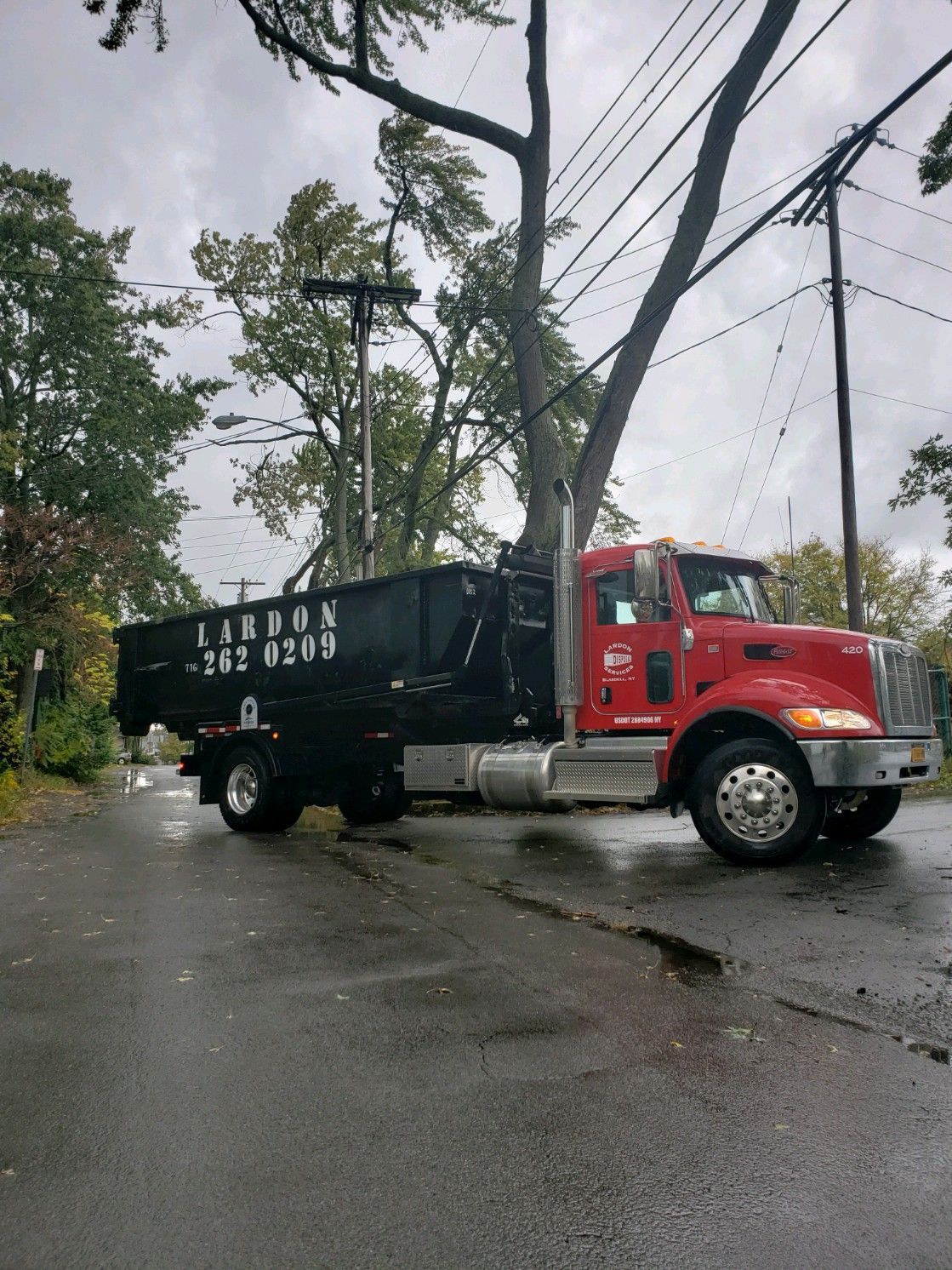 A dump truck is parked on the side of the road
