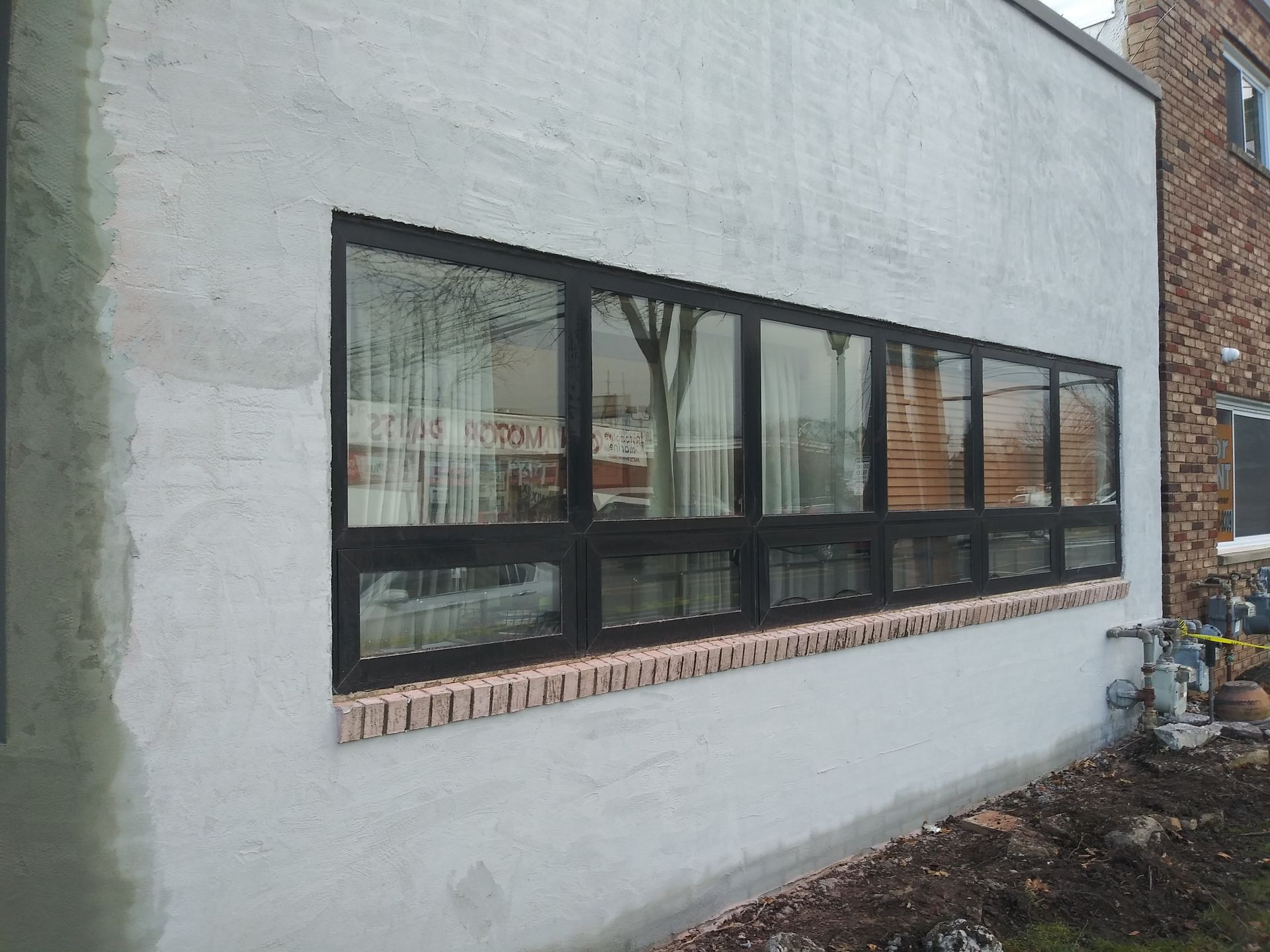 Exterior wall with a long horizontal window and reflections in the glass