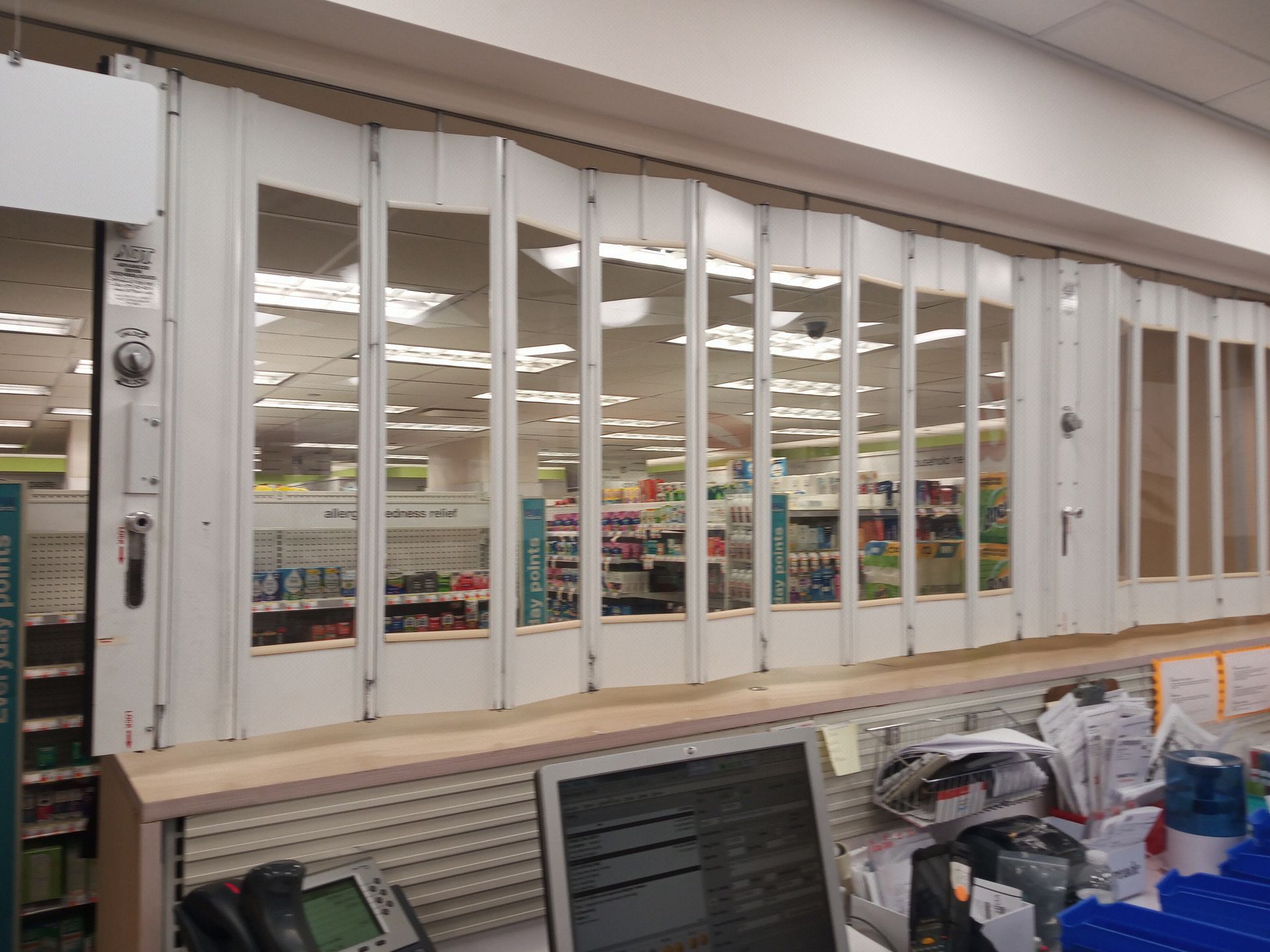 Store front with large windows seen from a checkout counter inside a retail shop
