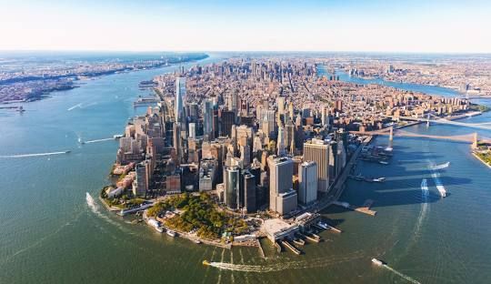 Aerial view of Lower Manhattan and surrounding waterways on a clear day