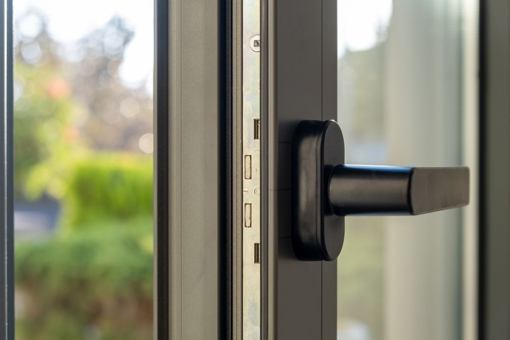Black Window Handle on a Gray Frame; Partially Open — Working Windows in Lennox Head, NSW