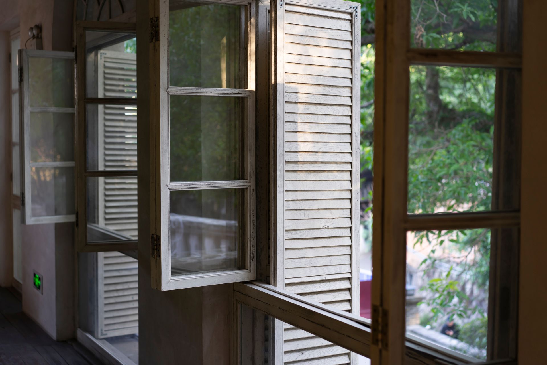 Open Windows With White Shutters Looking Out Onto Green Trees — Working Windows in Sunshine Coast, QLD