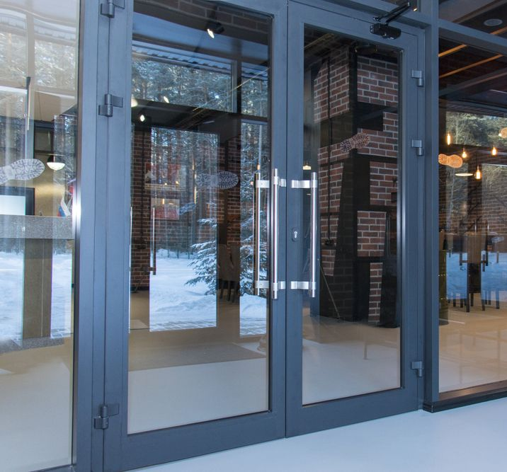 Glass Entrance Doors With Silver Frames, View Into a Building Interior — Working Windows in Ocean Shores, NSW