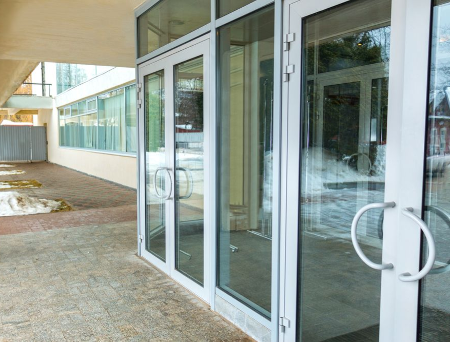 A Ground-level Entrance With Glass Double Doors in Light-colored Frames  — Working Windows in Byron Bay, NSW