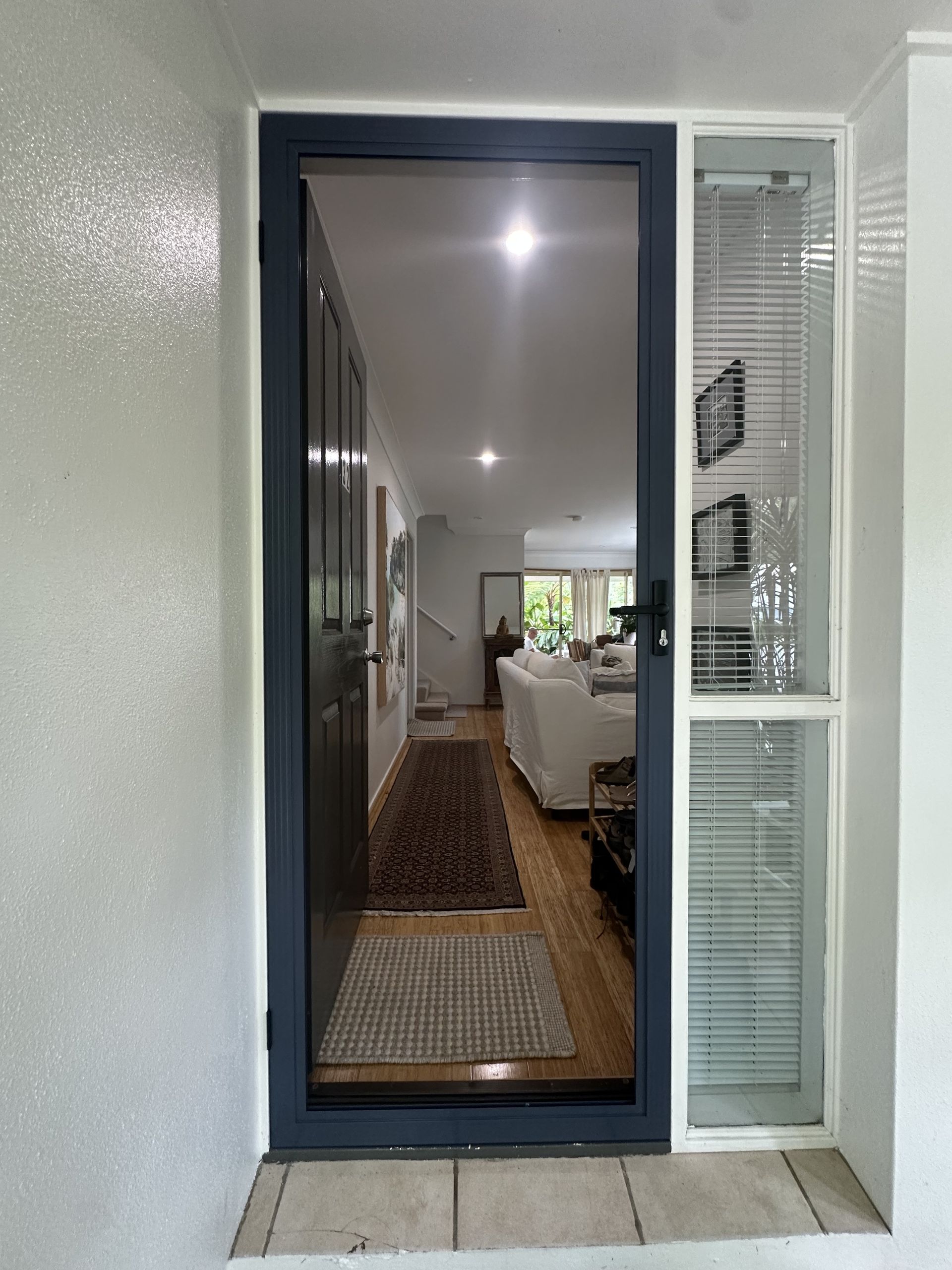 Open Front Door With Navy Trim, Showing a Bright Living Room — Working Windows in Caloundra, QLD