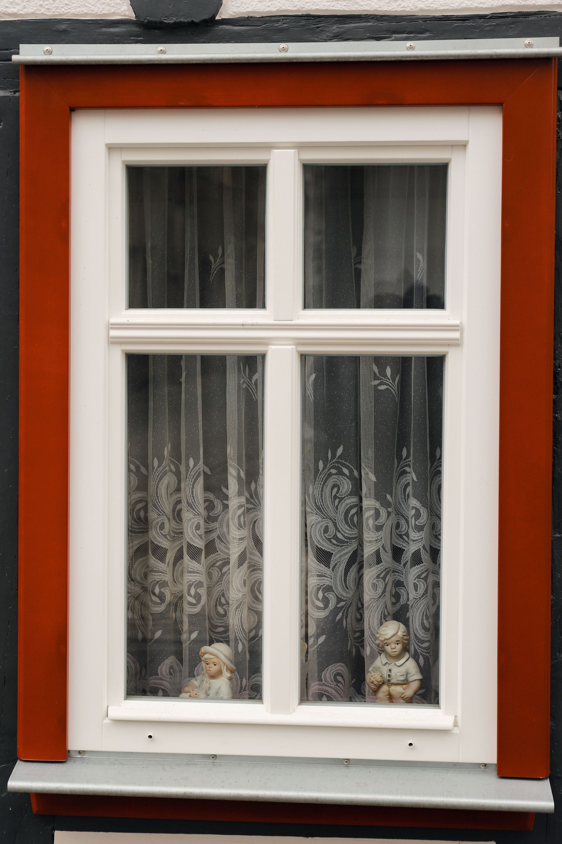 White-framed Window in a Red Wall With Lace Curtains — Working Windows in Maroochydore, QLD