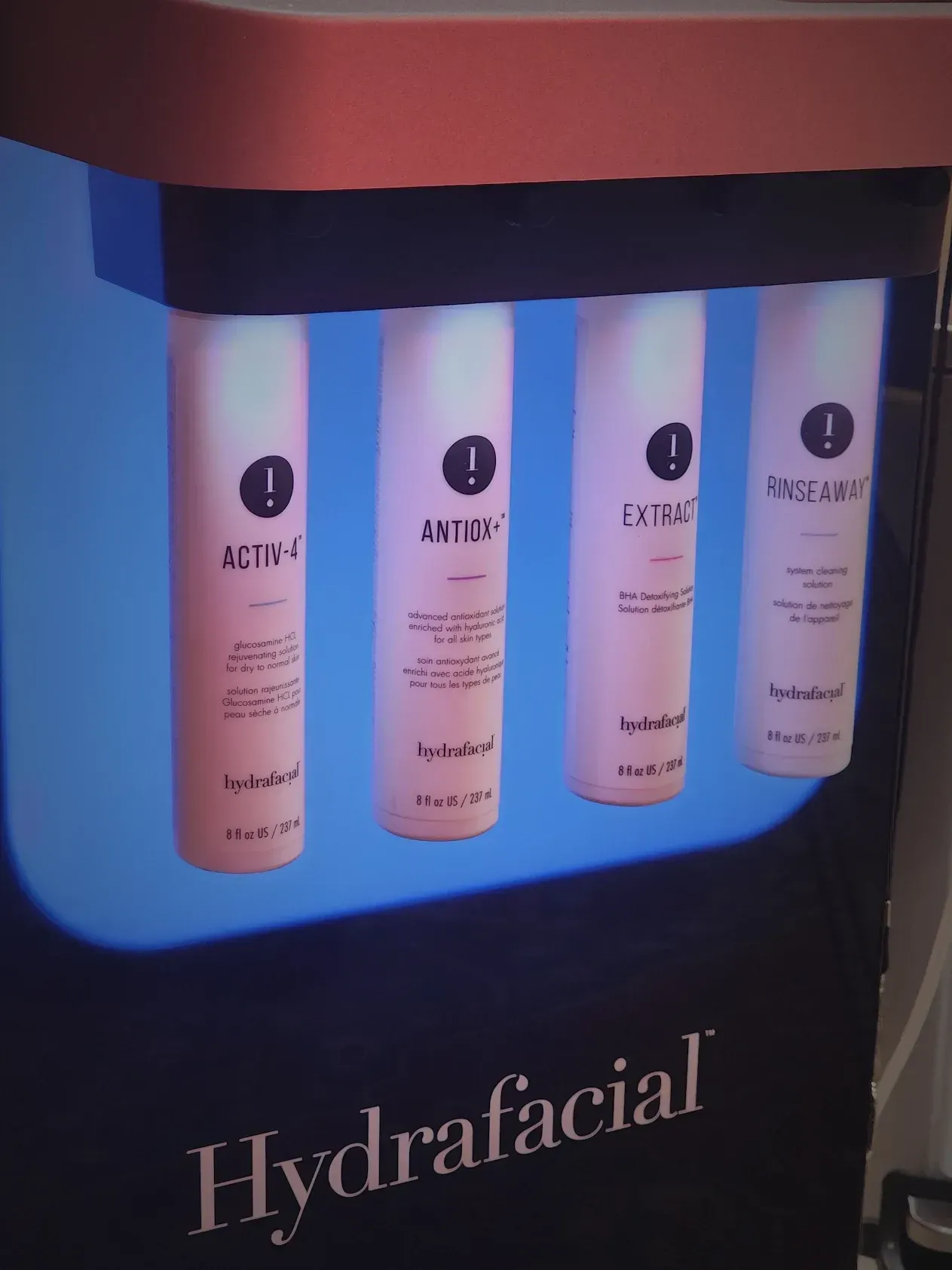 Four bottles of hydrafacial are on display