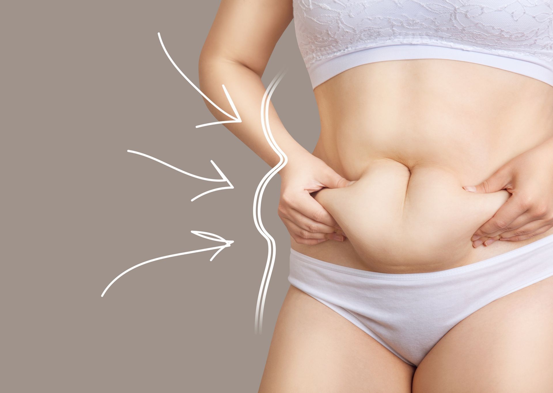 A person holds a fold of abdominal skin, with hand-drawn white arrows pointing toward the waistline.