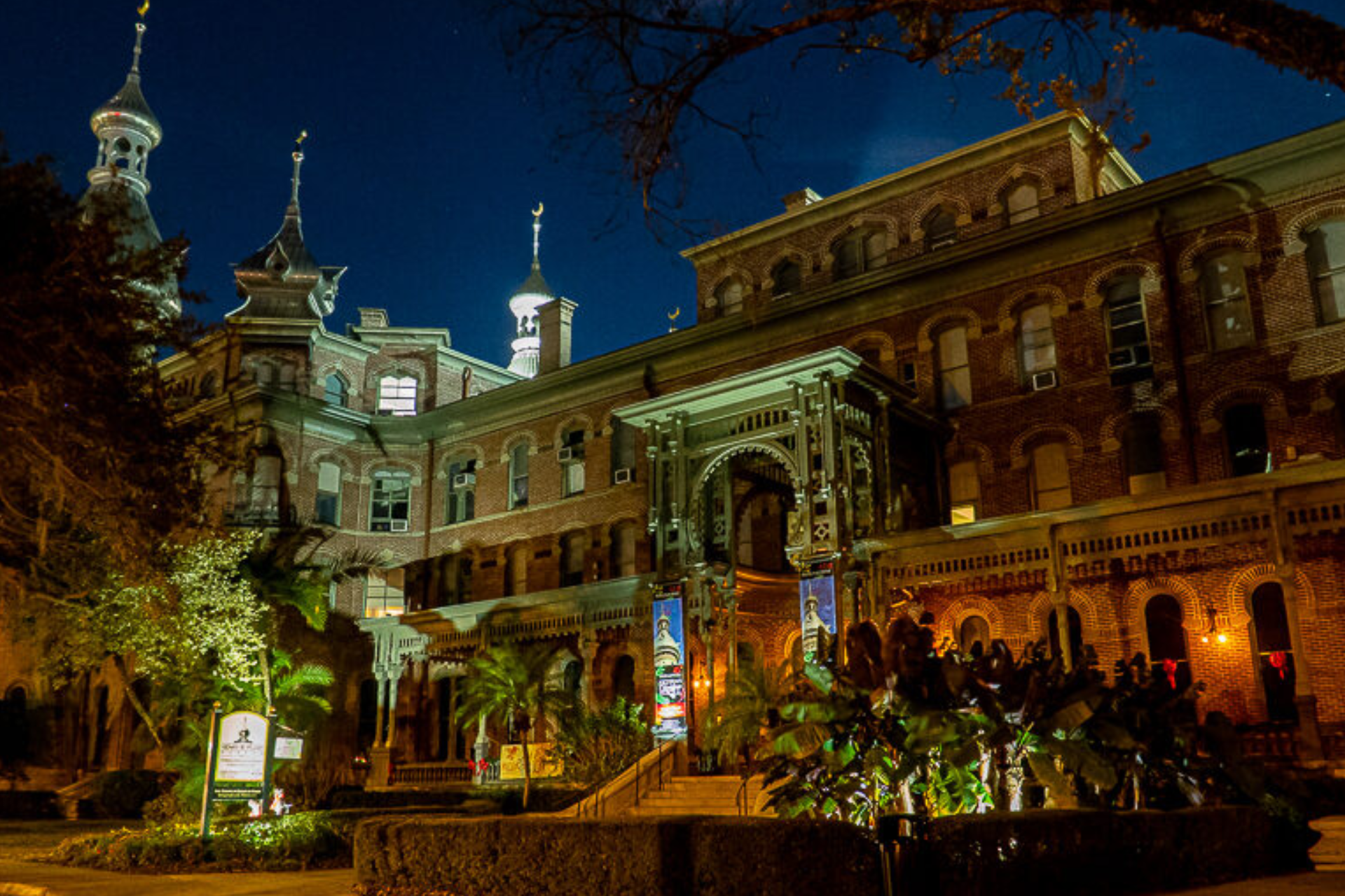 A large brick building is lit up at night.