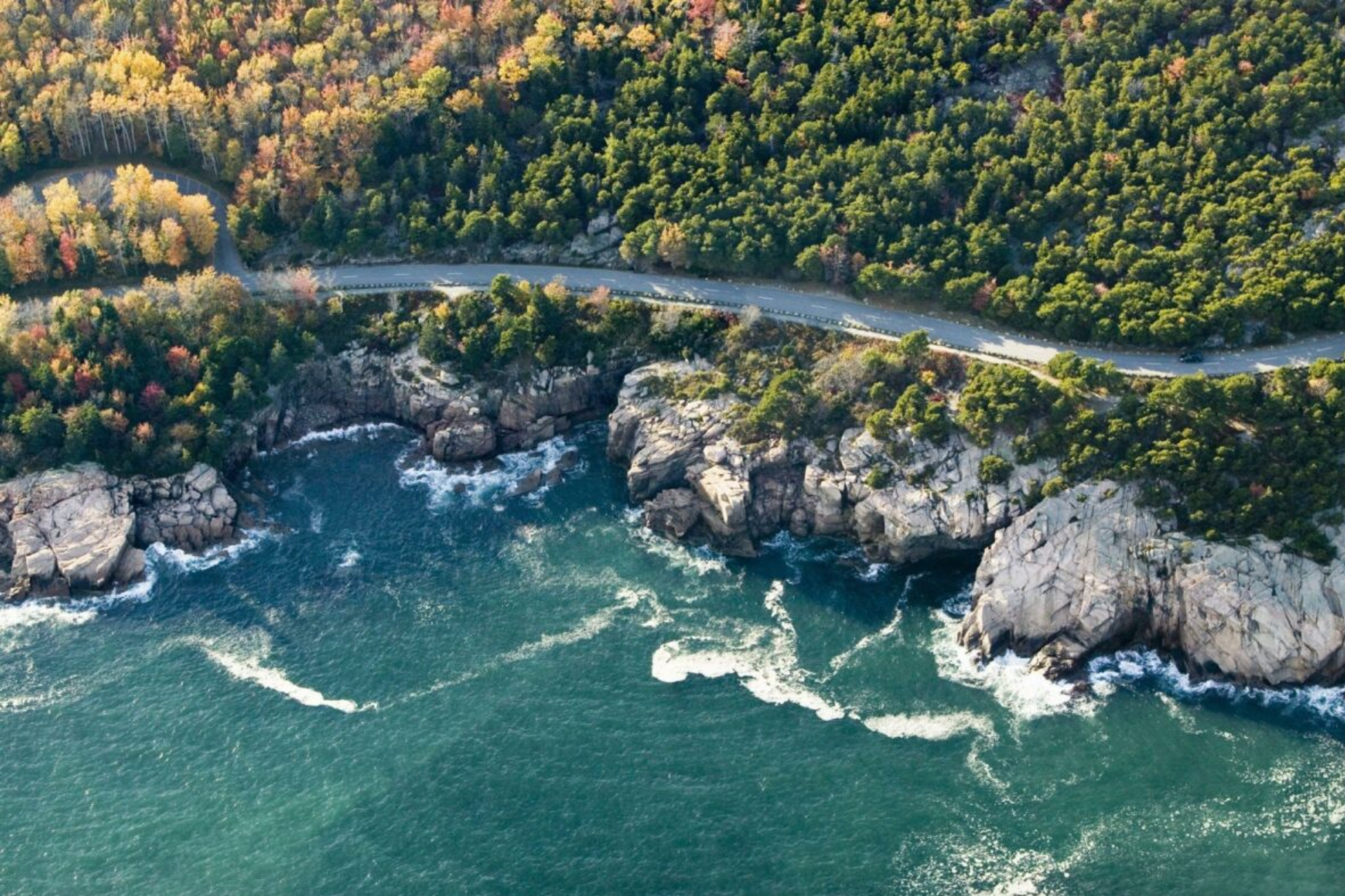 An aerial view of a cliff overlooking a body of water