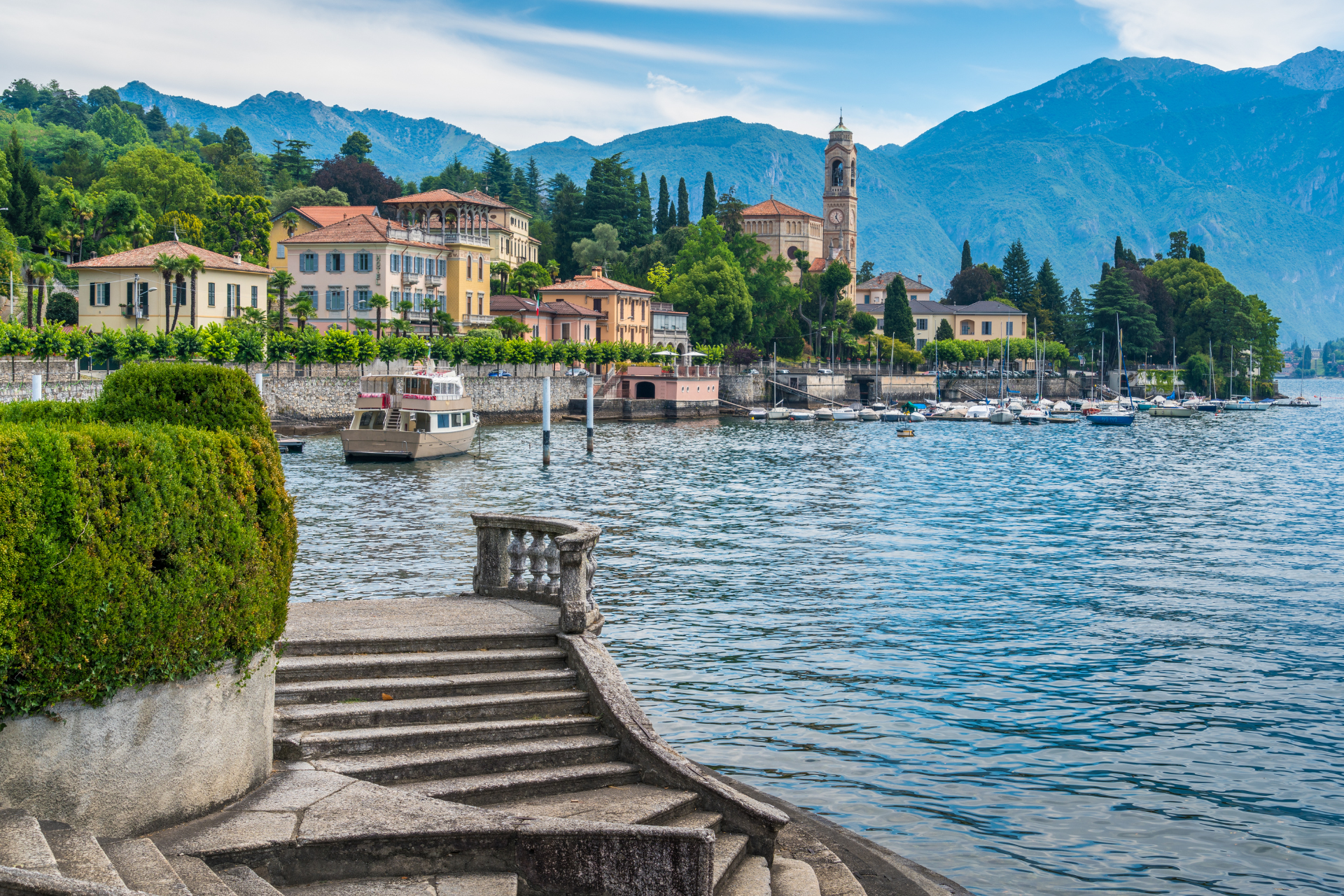 There are stairs leading up to a lake with mountains in the background.
