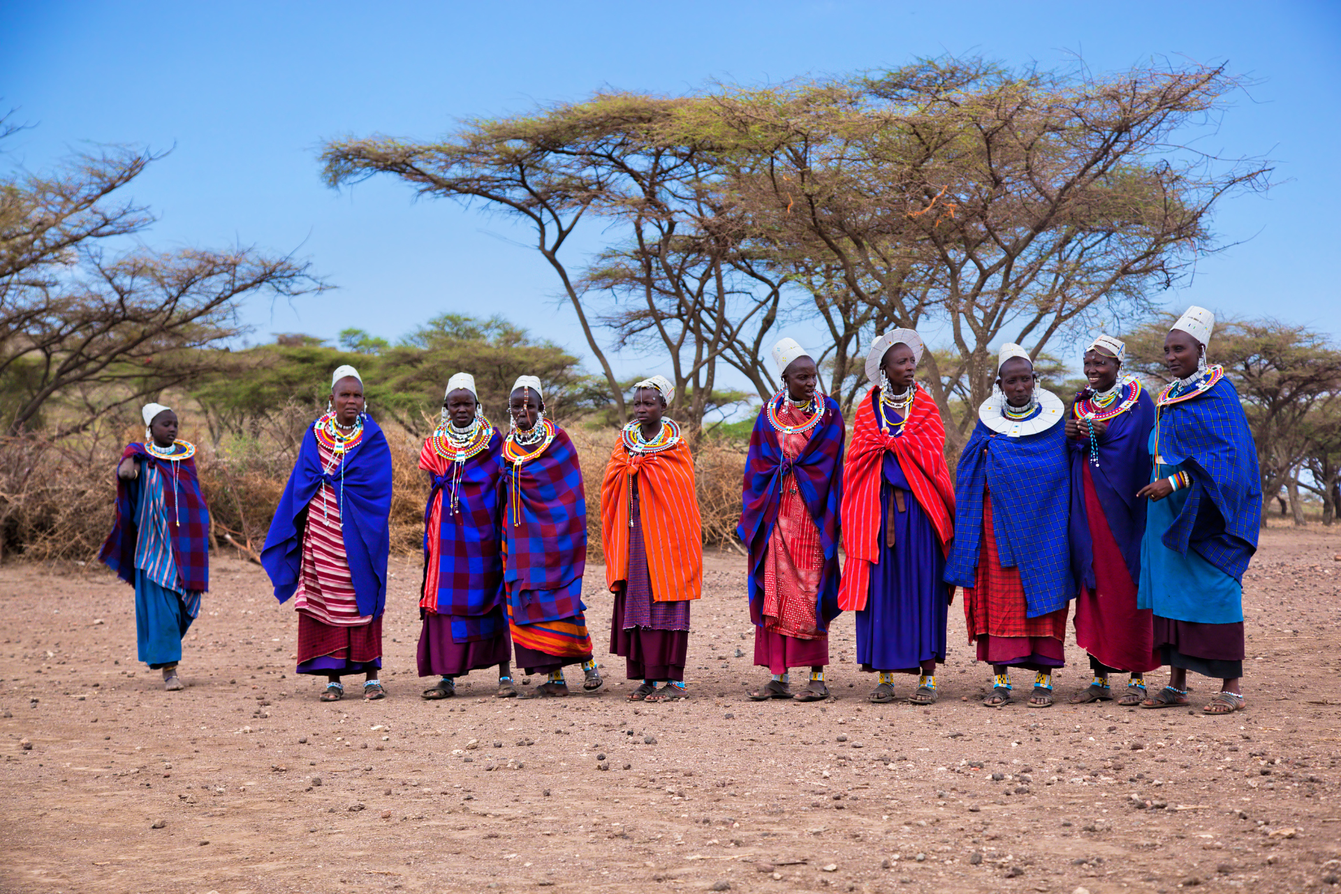 A group of people are standing next to each other in a field.
