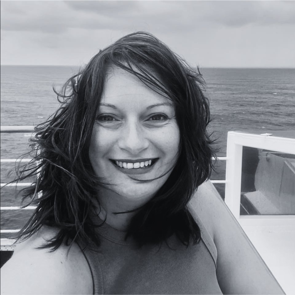 A woman is smiling in a black and white photo