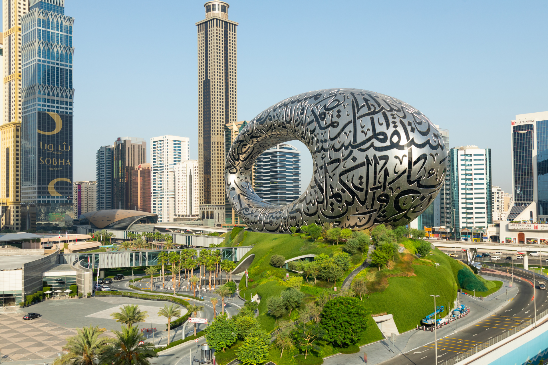 A large building is sitting on top of a hill in the middle of a city.