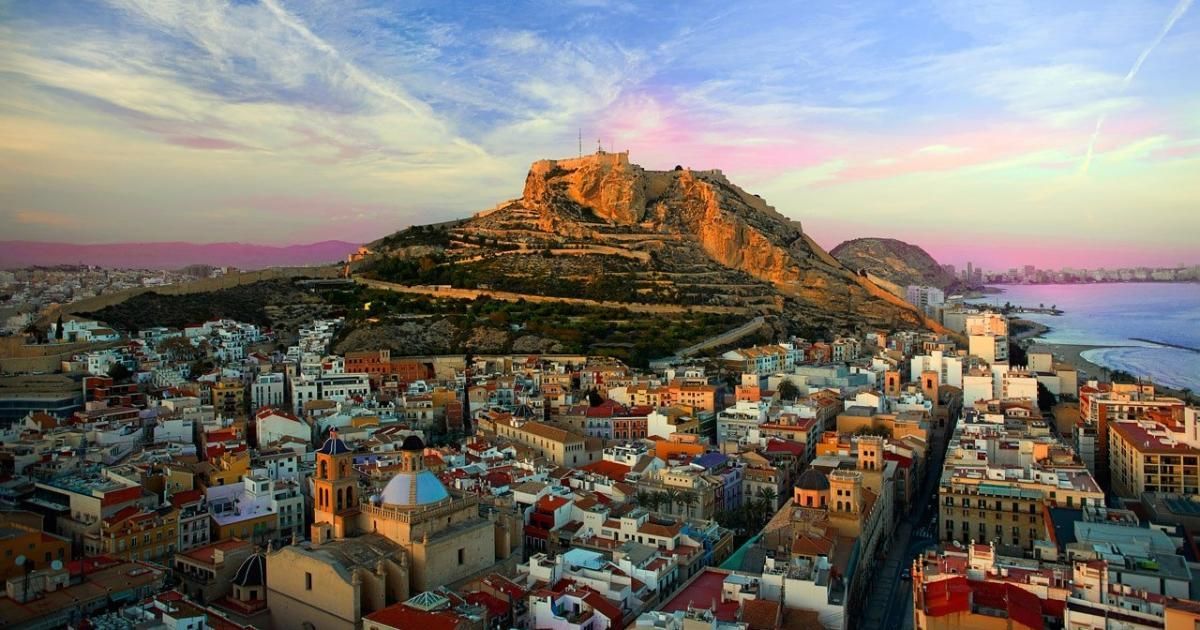 An aerial view of a city with a mountain in the background.