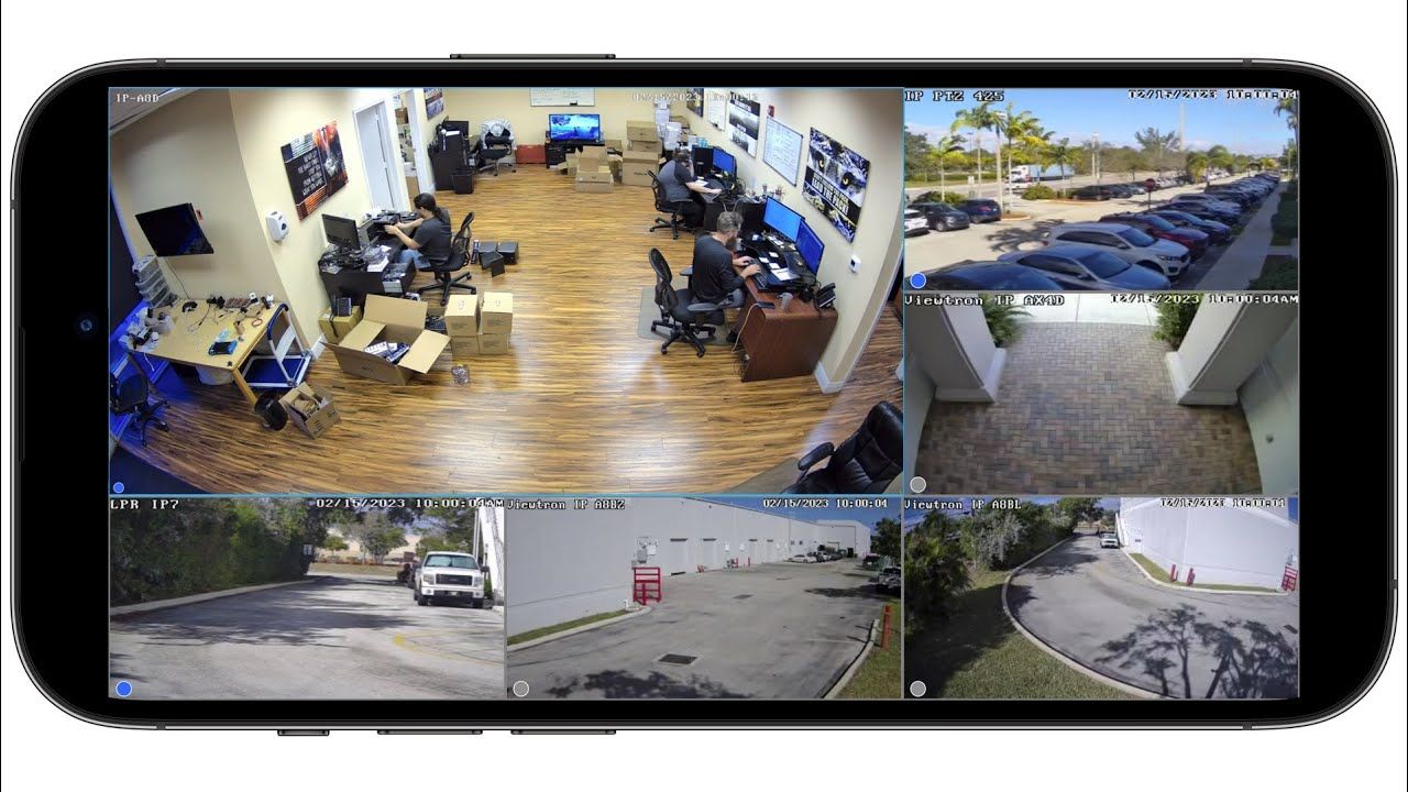 Smartphone Screen Displaying Multiple Surveillance Camera Views Of An Office And Outdoor Areas — Advanced Alarms Mackay Pty Ltd In South Mackay, QLD