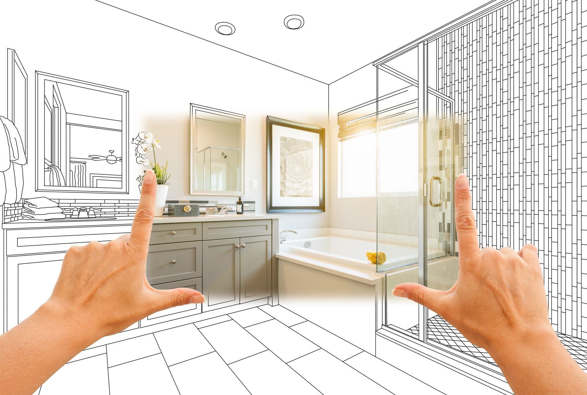 Hands framing a bathroom sketch overlaying a completed renovation: vanity, tub, shower.