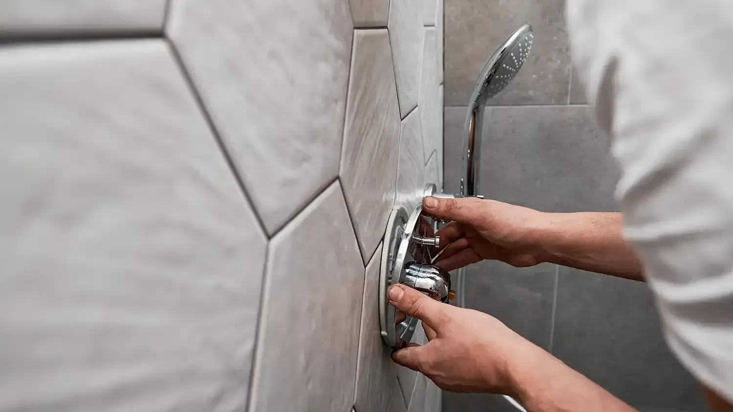Male plumber working on bathroom renovation at home.