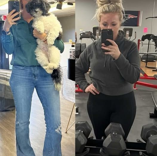 A woman is holding a dog and taking a selfie in a gym