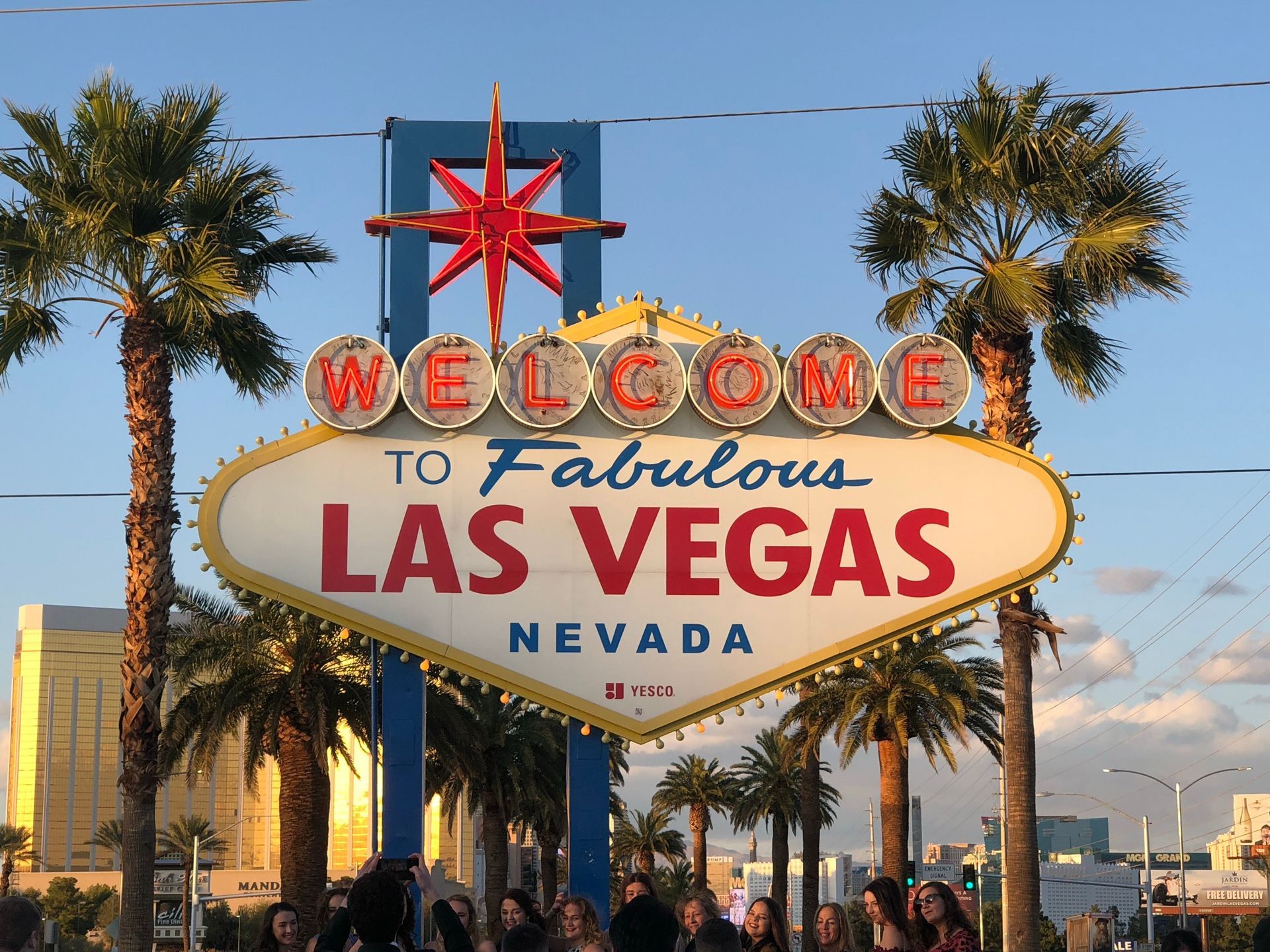 Welcome to Fabulous Las Vegas sign with palm trees against a blue sky