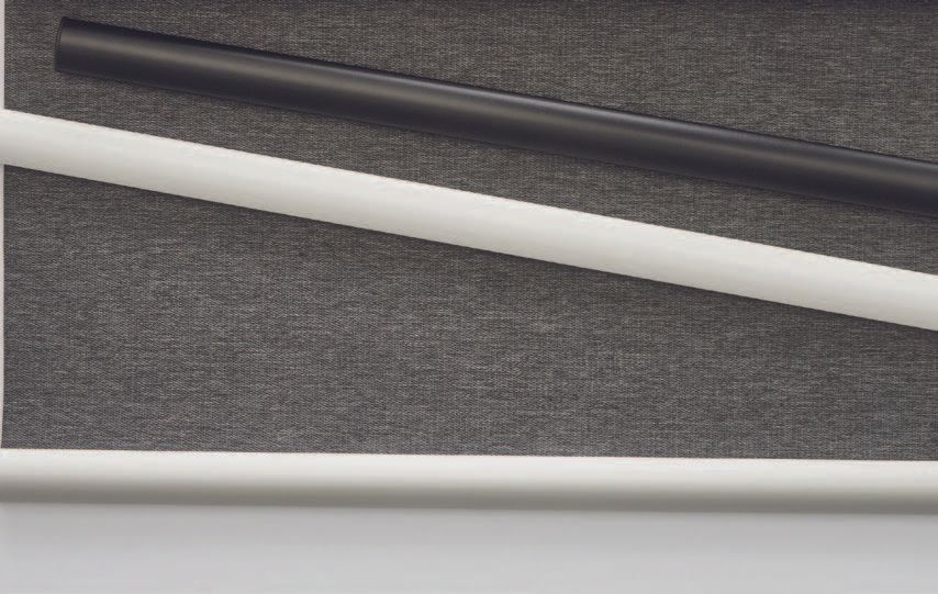 A black and a white pole are sitting on a table.