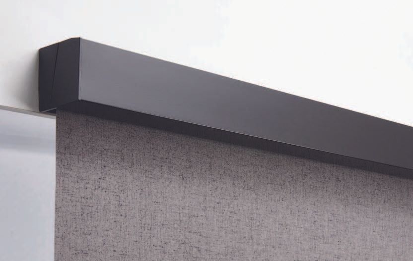 A close up of a black blind on a wall.