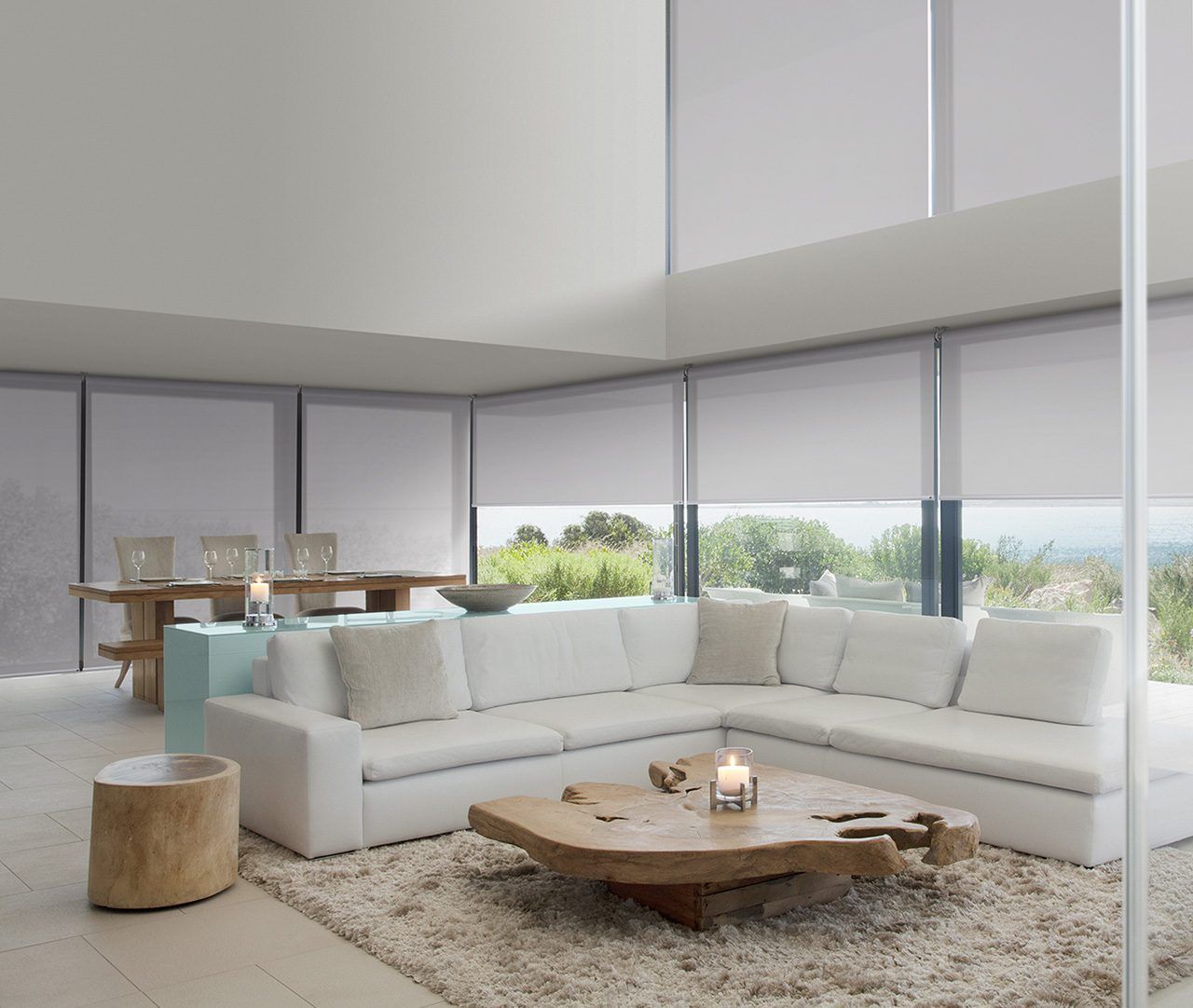 A living room with a white sectional couch and a wooden coffee table
