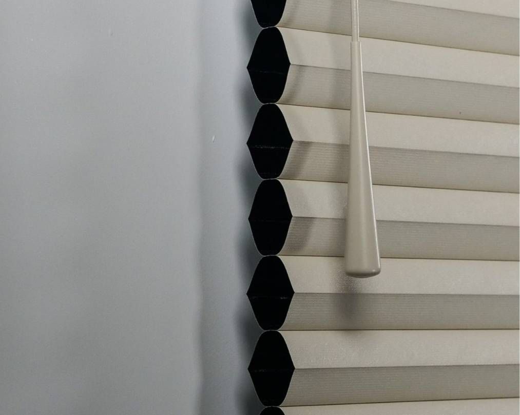 A close up of a blind with black beads on it